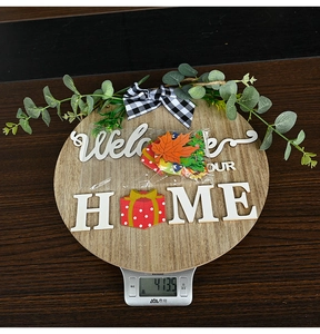 Detail of wooden welcome sign with 3D letters, eucalyptus leaves, and seasonal icons