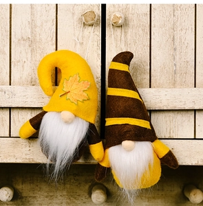 Close-up of autumn gnomes with maple leaf hats and plush beards for harvest decoration