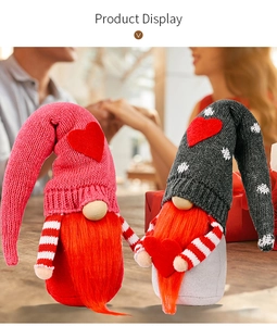 Detail of knitted Valentine gnomes with red heart hats and orange beards for home decor