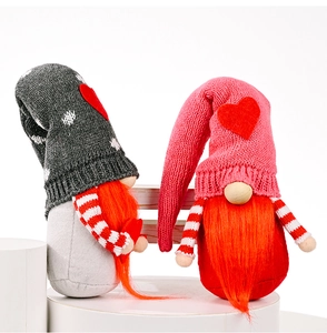 Detail of two knitted Valentine gnomes with hearts on gray and pink hats and long beards