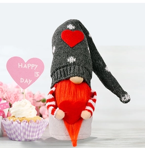 Macro detail of a knit gnome holding a red heart with a festive Valentine's Day background