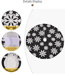 Detail view of grey Christmas tree skirt featuring white snowflake patterns and Velcro closure