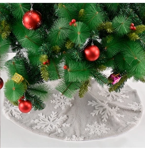 Detailed view of gray plush Christmas tree skirt with white embroidered snowflakes