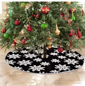 Detailed view of the gray Christmas tree skirt with white snowflake jacquard pattern