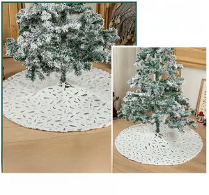 Detailed view of white faux fur Christmas tree skirt with silver foil feather patterns