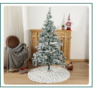 Detail of white faux fur Christmas tree skirt with gold foil pattern in cozy home setting