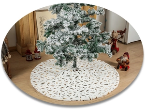 Detail of white faux fur Christmas tree skirt with golden feather foil pattern texture
