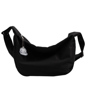 Minimalist black canvas tote bag with adjustable strap and cloud charm for daily casual use