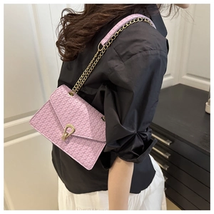 Detail of lavender woven crossbody bag featuring a gold clasp and metal chain strap