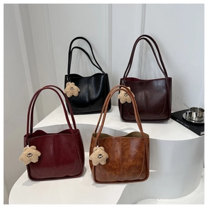 Four colors of textured faux leather tote bags with cute plush star charms for women