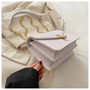 Close-up of lilac woven crossbody bag with gold metal buckle and triple-layer structure
