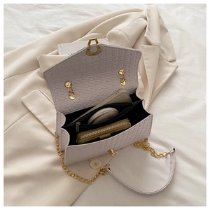 Detailed interior of purple faux crocodile crossbody bag with chain strap and compartments