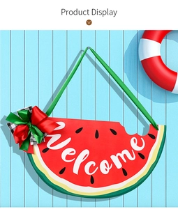 Detail of summer watermelon welcome sign with vibrant bow decoration and silk ribbons
