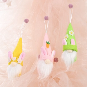 Detailed view of three Easter gnome plush pendants with bunny ears and floral accents