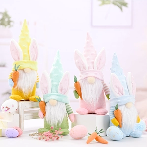 Close-up of four Easter gnomes with rabbit ears holding carrots on wooden display