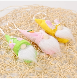 Detailed view of three felt Easter gnomes with rabbit ears on a natural woven background
