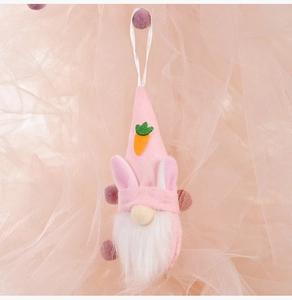 Pink Easter gnome plush with bunny ears and carrot applique on soft tulle background