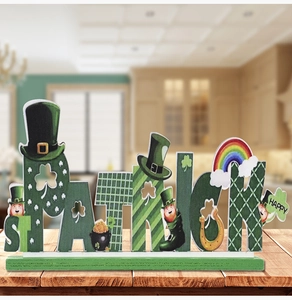 Close-up of Saint Patrick's Day wooden tabletop sign with green clovers and rainbow detail