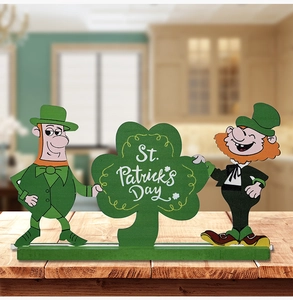 Detail of St. Patrick's Day wooden gnome ornaments with clovers on a rustic table