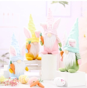 Close-up of colorful Easter gnome plush set with bunny ears holding orange carrots