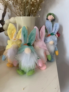 Close-up of four colorful Easter bunny gnomes with long ears and white fuzzy beards