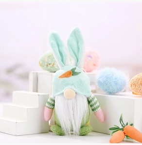 Detail of Easter gnome plush with green rabbit ears hat and carrot decor on white stand