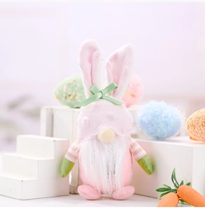 Pink Easter gnome plush with bunny ears and white beard on a decorative display