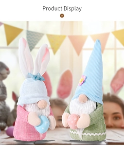 Detail view of Easter gnomes with rabbit ears holding colorful polka dot eggs