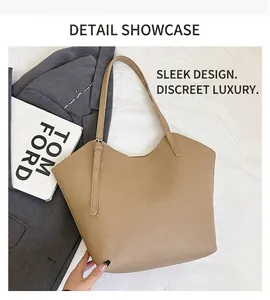 Detail view of khaki leather tote bag featuring a textured lychee grain and V-shape opening