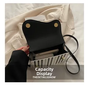 Interior view showing the large capacity of the piano key print crossbody bag