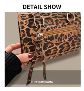 Detail of leopard print handbag showing synthetic leather texture and silver hardware