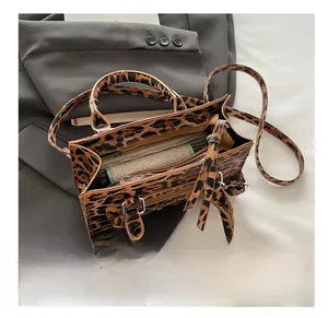 Internal view of leopard print tote showing large capacity and zipper pocket