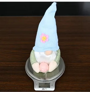 Easter gnome plush doll weighing 75.5g on a scale showing light blue hat and pink egg