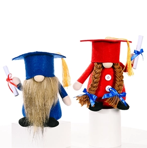 Detail of blue and red graduation gnomes with mortarboard hats on display pedestals