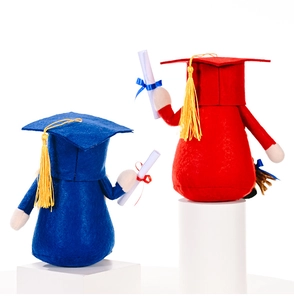 Close-up of red and blue graduation gnomes with tassels and scrolls on pedestals