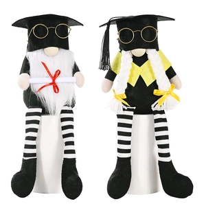 Pair of graduation gnomes wearing black caps and glasses on white display stands