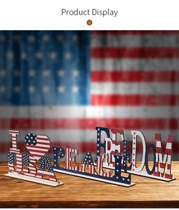 Macro detail of wooden USA, Peace, and Freedom ornaments with American flag print patterns