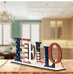 Close-up of HELLO wooden sign with American flag pattern on rustic tabletop