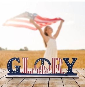 Detailed view of wood GLORY sign with American flag stars and stripes on table