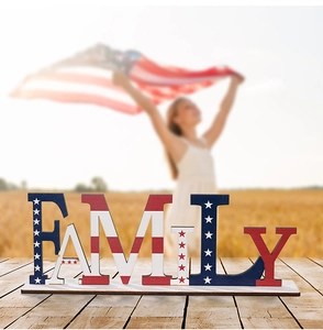 Detail of wooden FAMILY sign with American flag stars and stripes on a rustic table