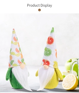 Close-up of summer fruit themed gnomes with orange and lime prints and white plush beards