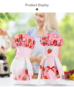 Close-up of strawberry themed kitchen gnomes with chef hats and aprons for home decor