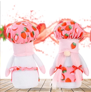 Detail of strawberry chef gnome plush set featuring pink prints and apron decorations