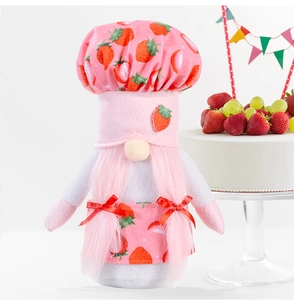Detail of pink strawberry gnome with chef hat and braided hair for kitchen decor