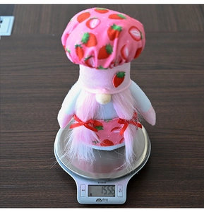 Strawberry gnome chef plush decoration on a digital scale showing weight details