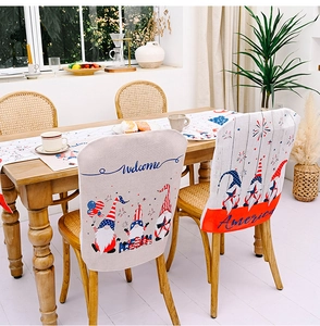 Close-up of July 4th chair covers and table runner with festive gnome designs