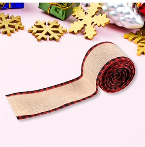 Macro shot of linen-style ribbon with red and black buffalo plaid edges for Christmas decor