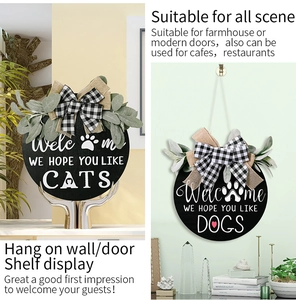 Detail of rustic wooden welcome signs with buffalo plaid bows and cat/dog paw prints