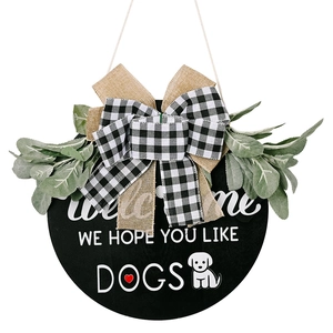 Rustic welcome sign with black wood base, burlap bow, and greenery for dog lovers decor