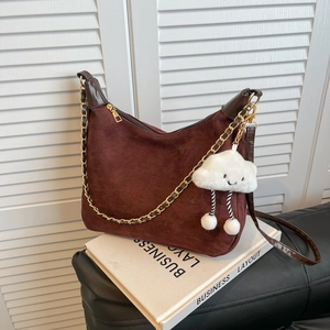 Large dark brown suede tote bag with golden chain strap and plush cloud charm